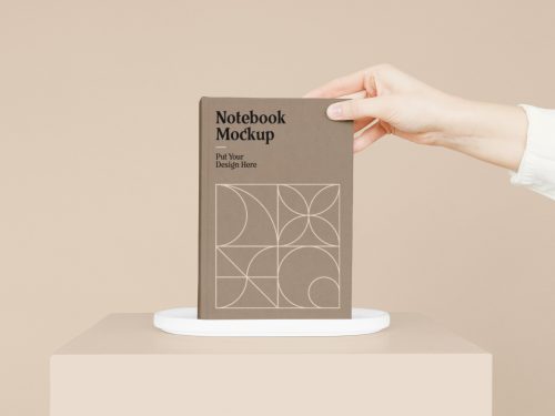 Notebook with Hand Mockup