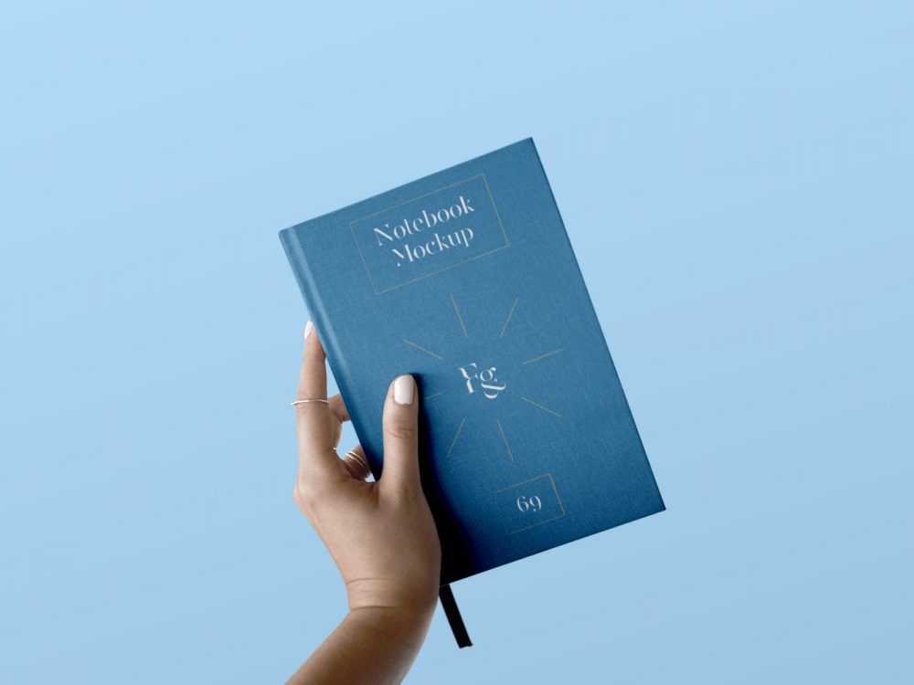 Hard Cover Notebook with Hand Mockup